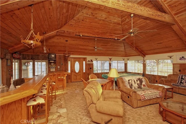 living room with wooden ceiling, a healthy amount of sunlight, and beam ceiling