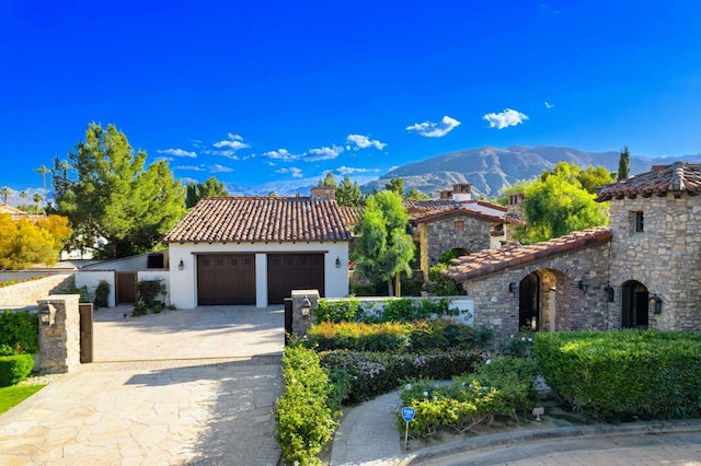 mediterranean / spanish-style house featuring a garage and a mountain view