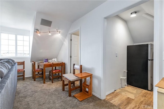 living area with light wood-type flooring and lofted ceiling