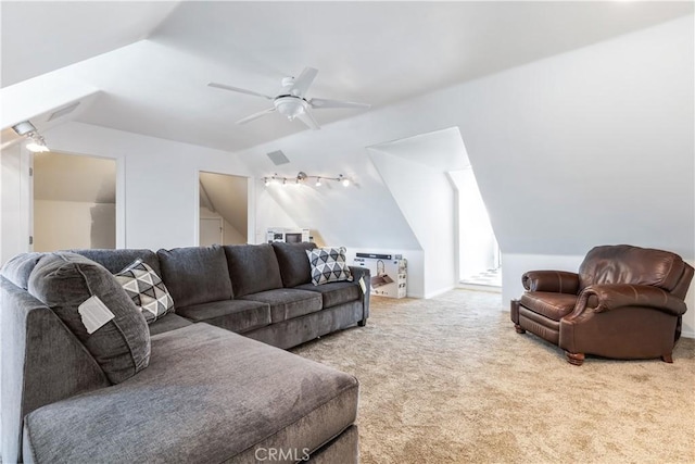 living room with ceiling fan, carpet floors, and vaulted ceiling