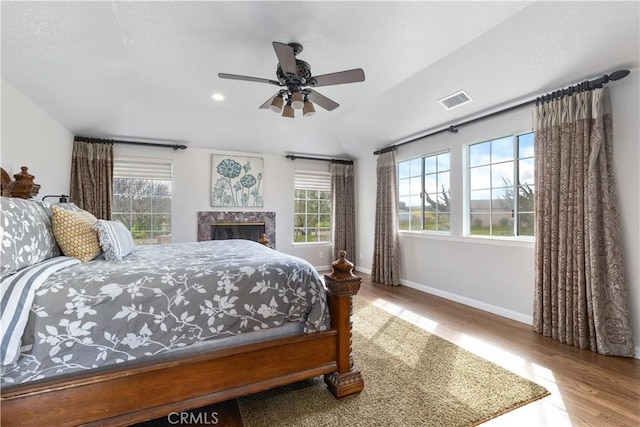 bedroom with hardwood / wood-style flooring, ceiling fan, and lofted ceiling