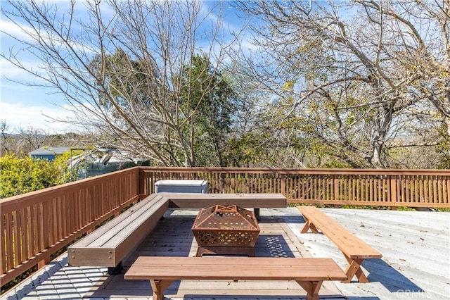 deck featuring an outdoor fire pit