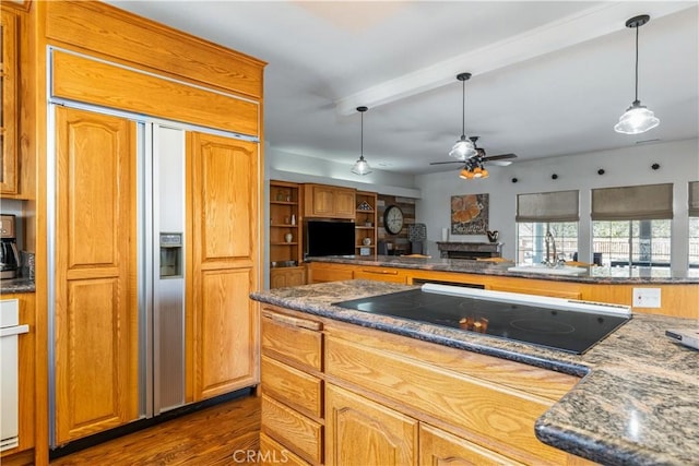 kitchen featuring dark wood-type flooring, sink, ceiling fan, paneled refrigerator, and black electric cooktop