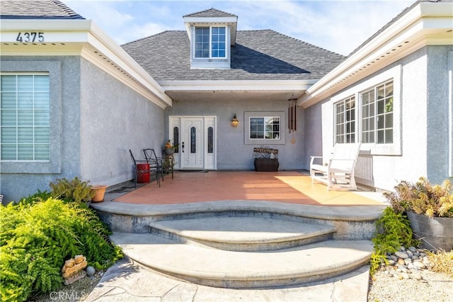 doorway to property with a patio