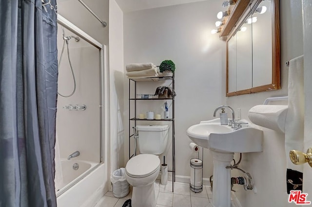 bathroom featuring tile patterned flooring, shower / bath combo, and toilet