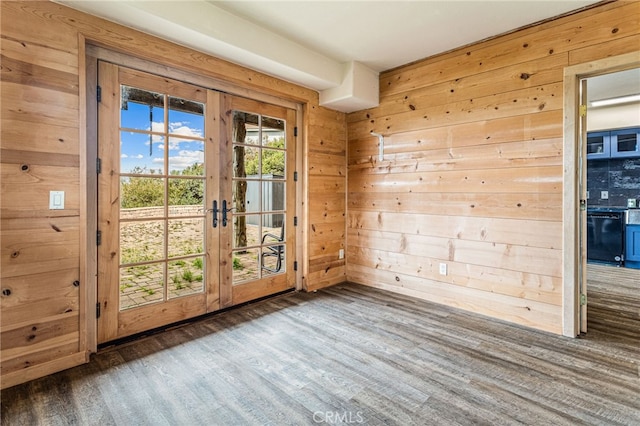 doorway featuring wooden walls, french doors, and dark hardwood / wood-style floors