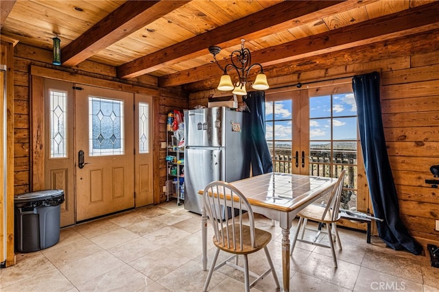 dining space featuring beamed ceiling, wooden ceiling, french doors, and a chandelier