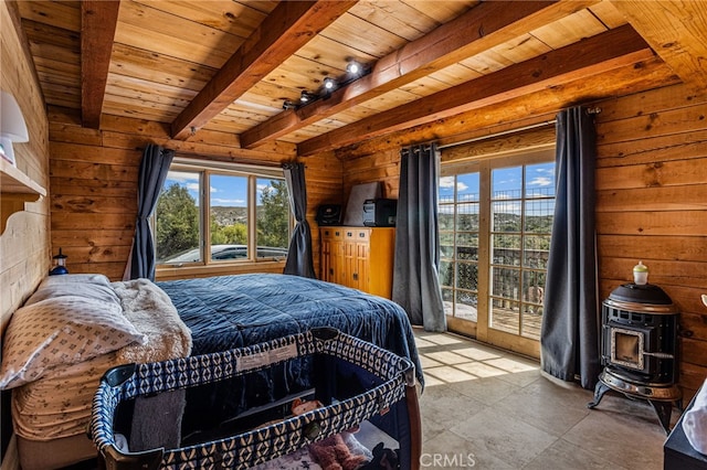 bedroom with access to exterior, track lighting, wooden ceiling, beamed ceiling, and a wood stove