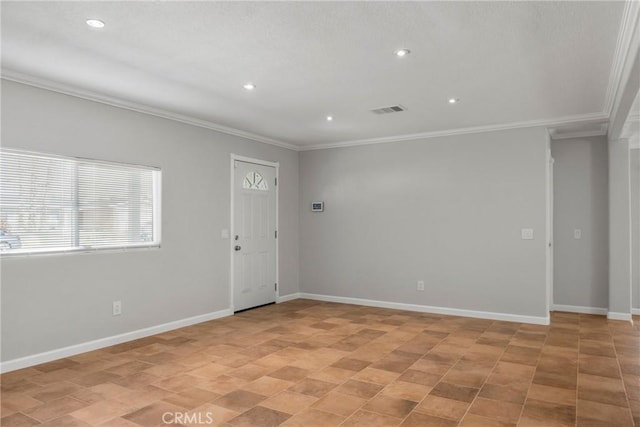 spare room featuring crown molding