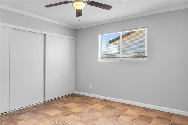 unfurnished bedroom featuring ceiling fan, a closet, and crown molding