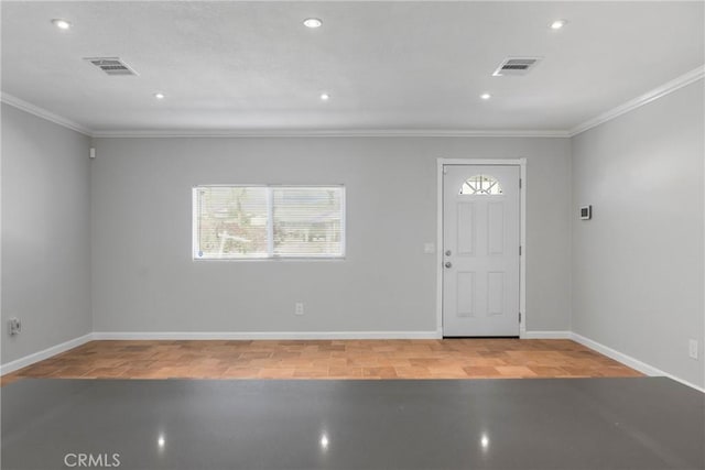 entryway featuring wood-type flooring and ornamental molding