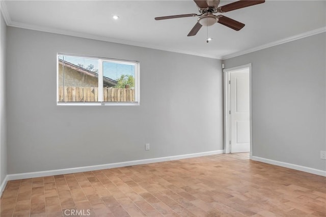 spare room with ceiling fan and crown molding