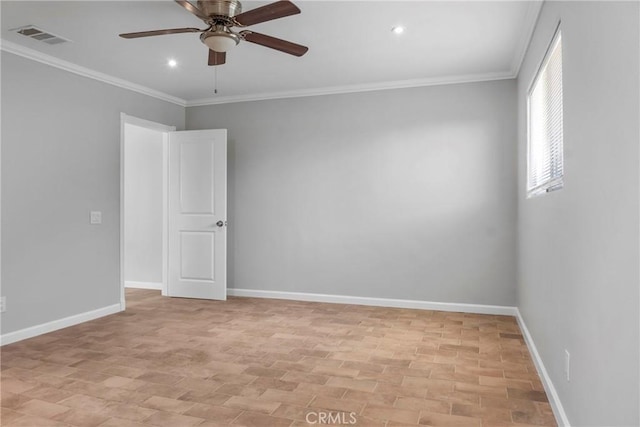 unfurnished room with ceiling fan and crown molding