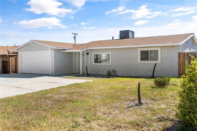 single story home featuring a garage, cooling unit, and a front lawn