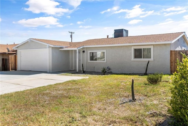 ranch-style home featuring a garage, a front yard, and central AC