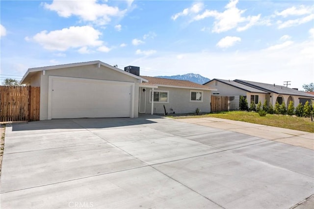 ranch-style home with a mountain view and a garage