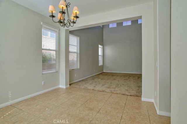 unfurnished room with light tile patterned floors and an inviting chandelier