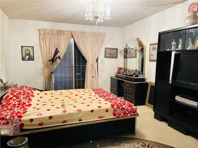 bedroom with a textured ceiling and a notable chandelier