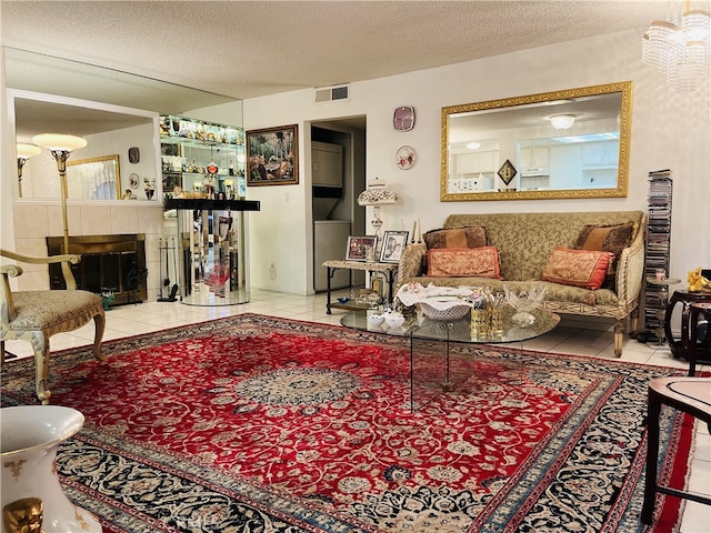 living room with a textured ceiling, tile patterned floors, and a fireplace