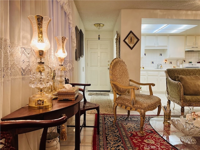 sitting room with sink and light tile patterned floors