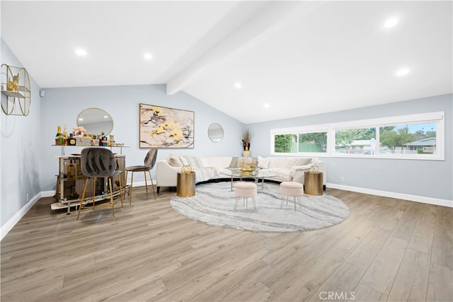 living room with vaulted ceiling with beams and light wood-type flooring