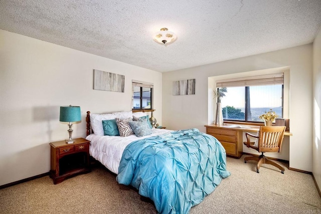 bedroom featuring carpet and a textured ceiling