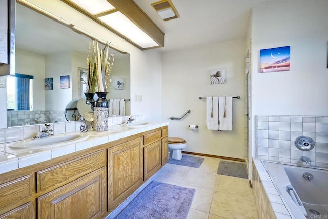 bathroom with toilet, tile patterned flooring, a washtub, vanity, and tasteful backsplash