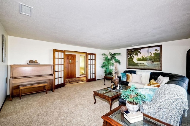 living room featuring french doors, a textured ceiling, and light colored carpet