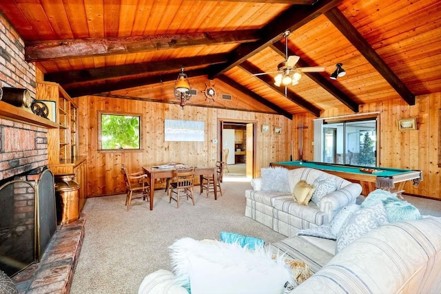 living room with wood ceiling, carpet, ceiling fan, a brick fireplace, and wood walls