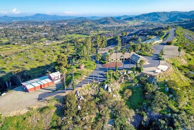 birds eye view of property featuring a mountain view