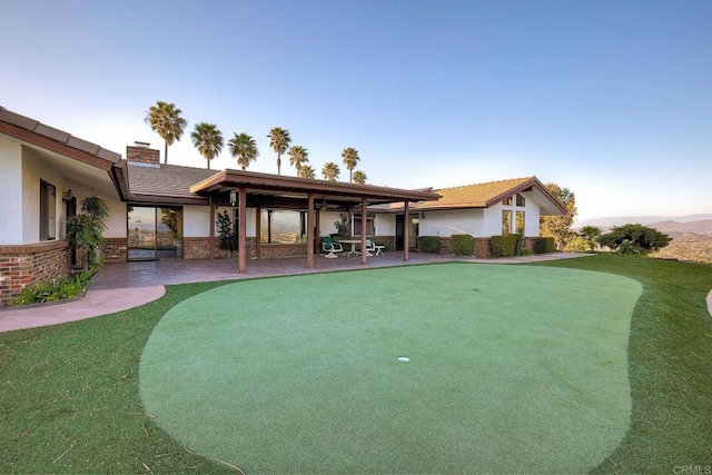 view of home's community featuring a patio area and a lawn