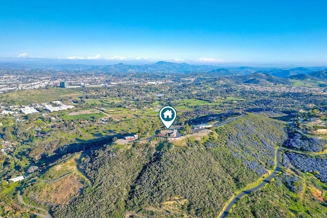 birds eye view of property with a mountain view