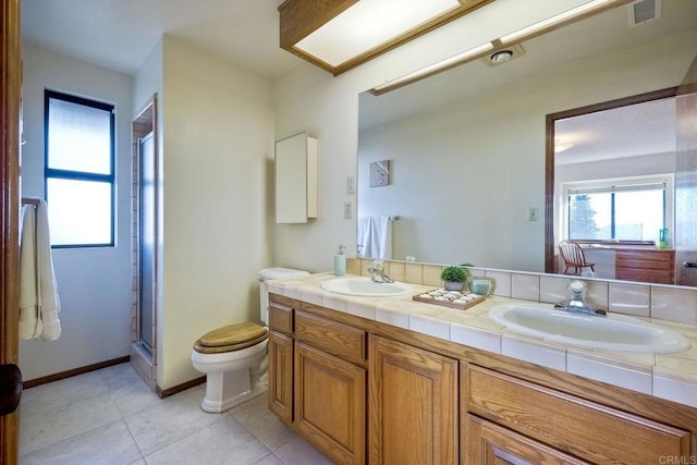 bathroom with vanity, a shower with shower door, toilet, and tile patterned flooring