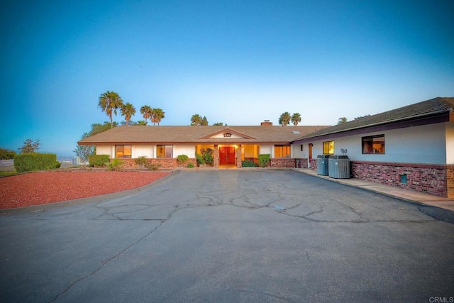 single story home featuring central AC unit