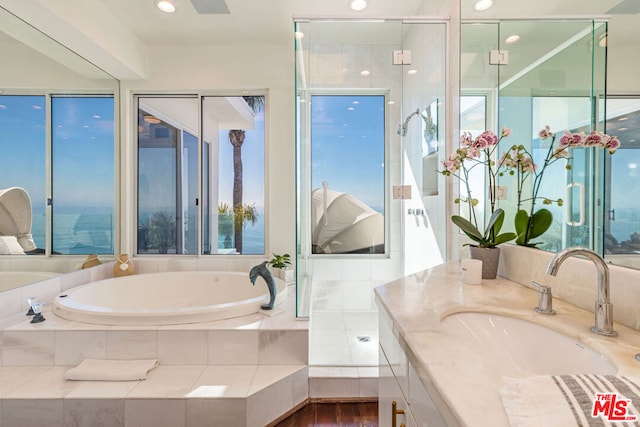 bathroom featuring vanity, a water view, and a healthy amount of sunlight