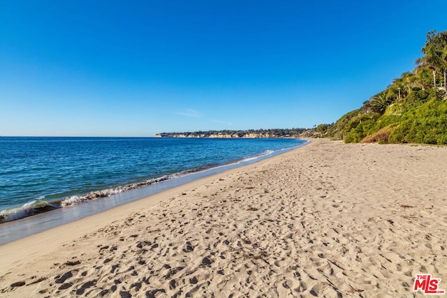 property view of water featuring a beach view