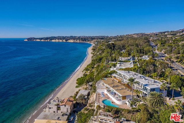 birds eye view of property featuring a water view and a beach view