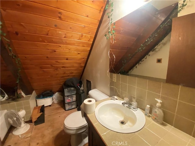 bathroom featuring toilet, wooden ceiling, decorative backsplash, lofted ceiling, and vanity