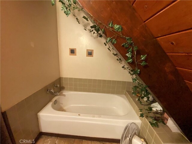 bathroom with a tub to relax in