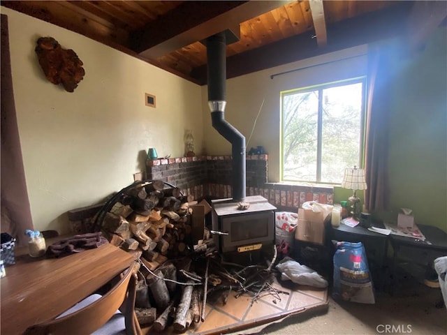 miscellaneous room with wood ceiling, beamed ceiling, and a wood stove