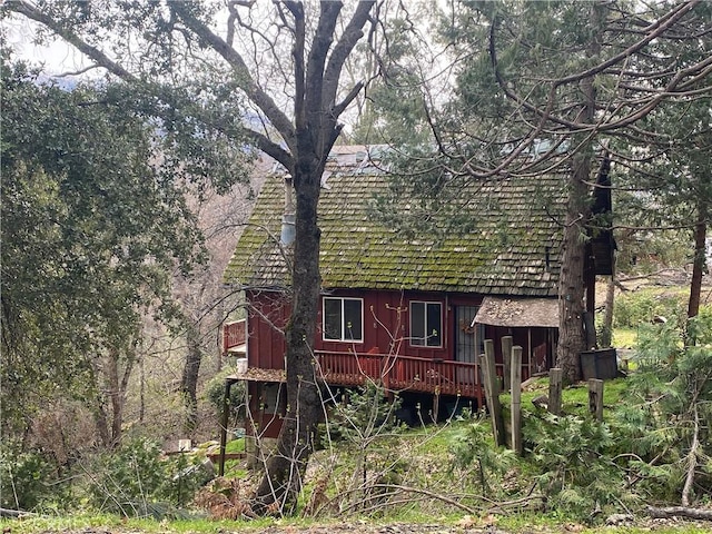 view of side of home with a wooden deck