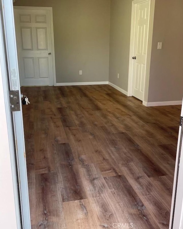 spare room featuring dark hardwood / wood-style floors