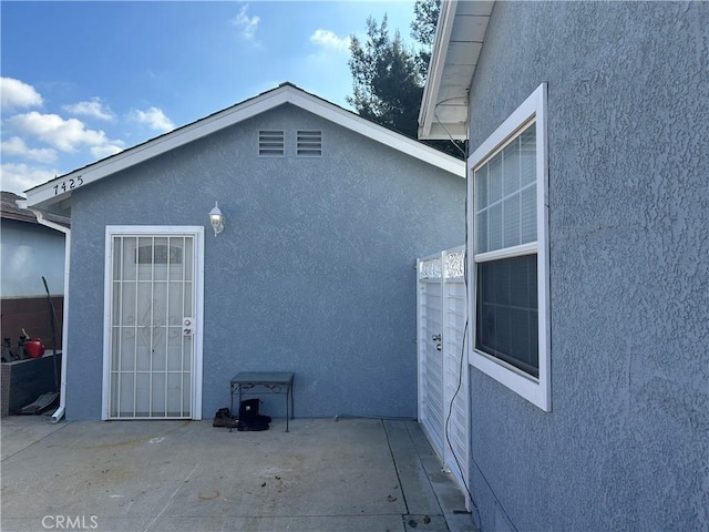 view of side of property featuring a patio