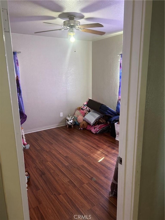 unfurnished bedroom with ceiling fan, hardwood / wood-style floors, and ornamental molding