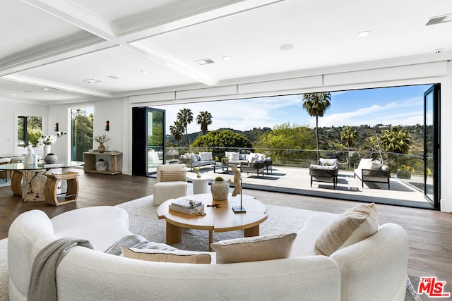 living room featuring wood-type flooring, coffered ceiling, and beam ceiling