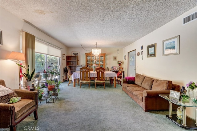 living room with carpet flooring, a textured ceiling, and a chandelier