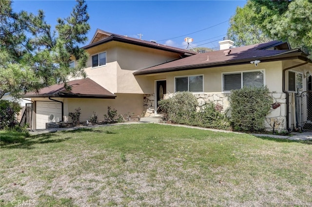 view of front of home with a garage and a front lawn