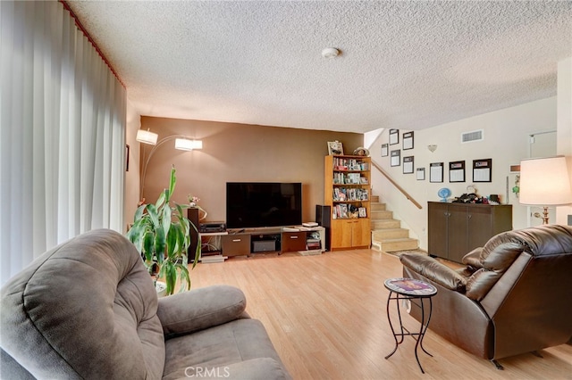 living room featuring a textured ceiling and hardwood / wood-style flooring