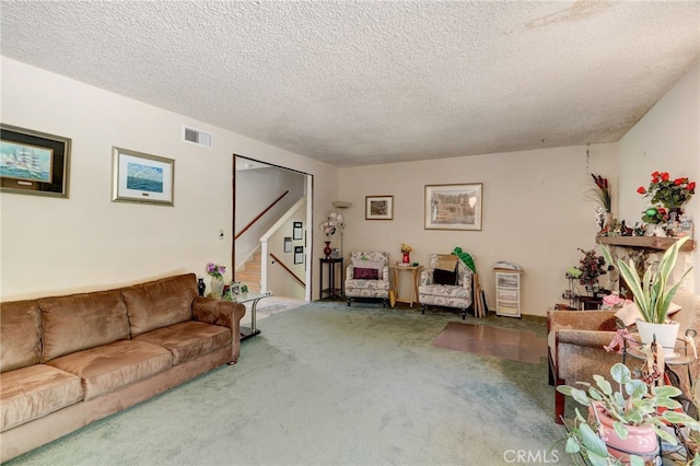 living room featuring carpet and a textured ceiling