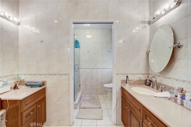 bathroom featuring walk in shower, vanity, tile walls, tile patterned flooring, and toilet